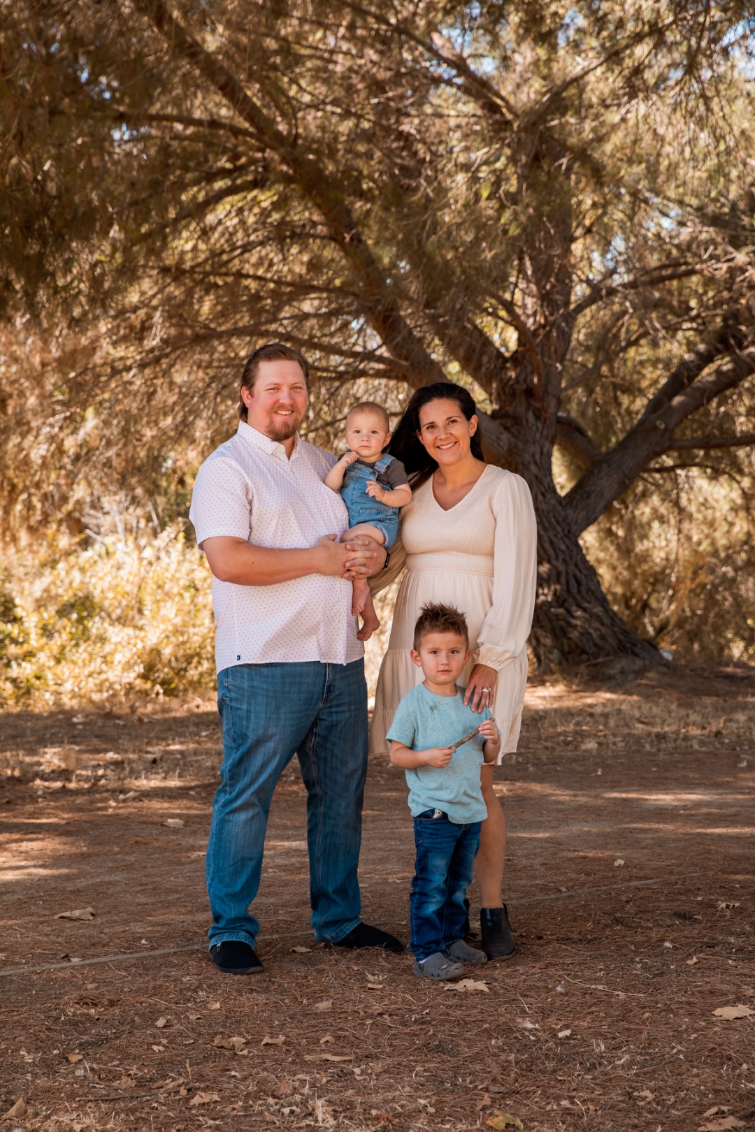 The Anchor and Spark family — two parents and their two young sons under a tree in Southern California